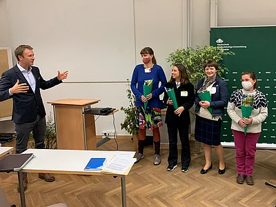 A professor welcomes the students 