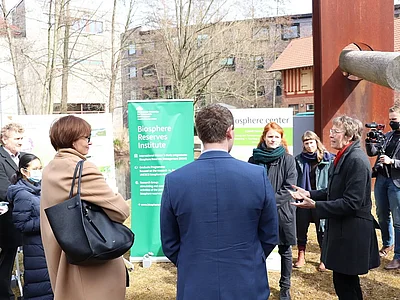 People standing around a poster