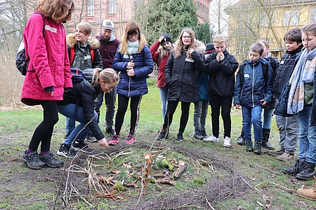 A group of children with a forest mandala